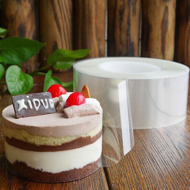 Layered cake with a clear acetate collar and roll