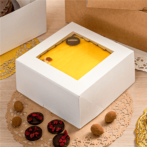 White windowed cake box with a cake inside